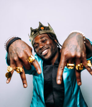 portrait of an hip hop music musician. Cinematic image of a man wearing party clothes and jewels